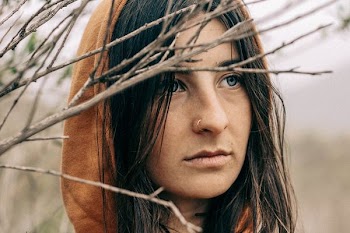 woman wearing brown hooded top near tree
