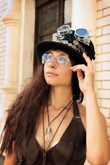 Woman Wearing Brown Leather Top Beside Concrete Building