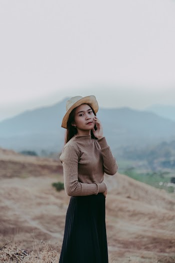 Woman Wearing Brown Long Sleeved Top And Hat 