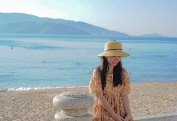 Woman Wearing Brown Off-shoulder Dress Near Ocean Water