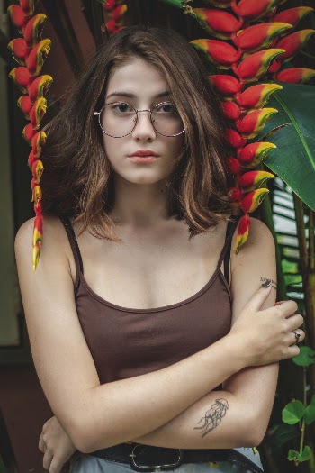 Woman Wearing Brown Spaghetti Strap Top Beside Red Leaf Plant