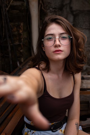 Woman Wearing Brown Spaghetti-strap Top Sitting on Brown Wooden Bench