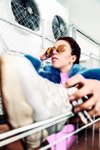 Woman Wearing Brown Sunglasses Holding Gray Shoe