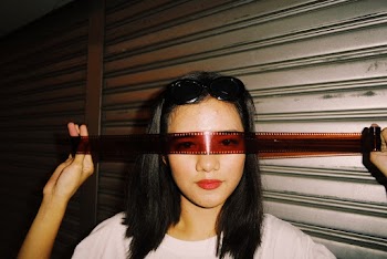 Woman Wearing Camera Film Onto Eyes