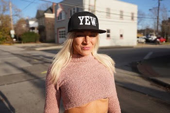 Woman Wearing Cap and Crop Top Standing on Road