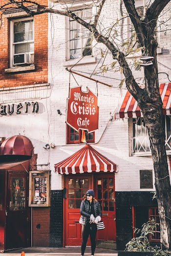 Woman Wearing Cap and Sunglasses Standing In-front of Store