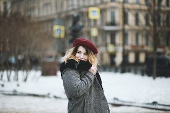 Woman Wearing Coat and Red Hat during Snowy Day