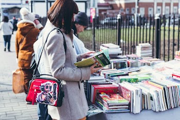 Woman Wearing Coat Holding Book