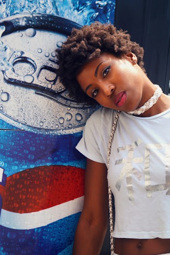 Woman Wearing Crop Top Near Pepsi Poster