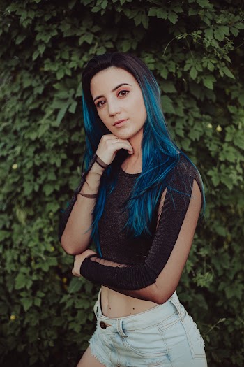 Woman Wearing Crop Top Standing in Front of Bush