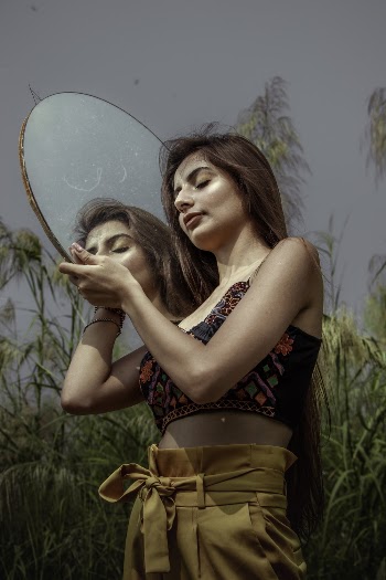 Woman Wearing Crop Top While Holding a Mirror