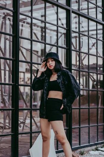 Woman Wearing Denim Jacket and Black Shorts