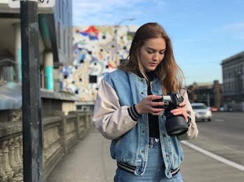 Woman Wearing Denim Jacket Holding Black Dslr Camera