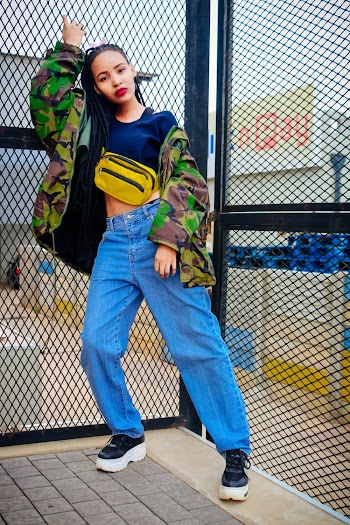 Woman Wearing Denim Jeans Standing Beside Chain-Link Fence