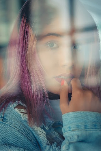 Woman Wearing Distressed Blue Denim Jacket