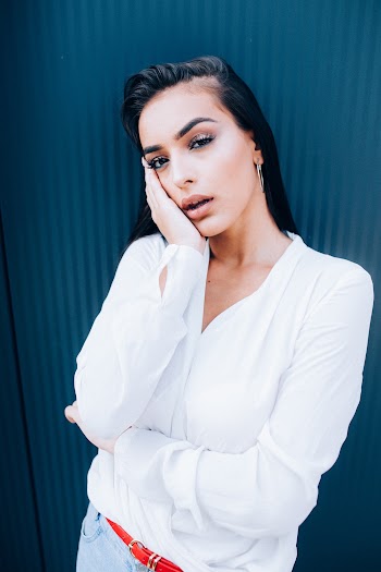 Woman Wearing Dress Shirt Holding Her Cheek