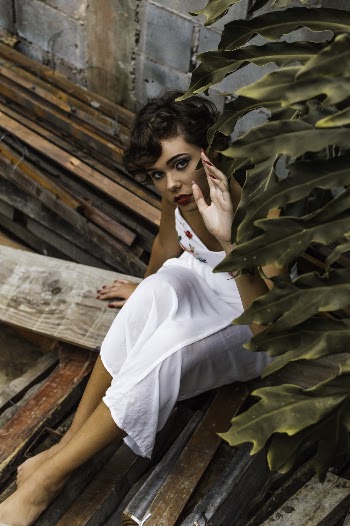Woman Wearing Dress While Sitting on Lumber