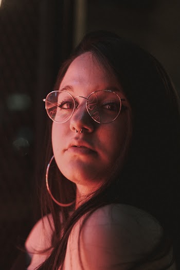 Woman Wearing Eyeglasses and Hoop Earrings