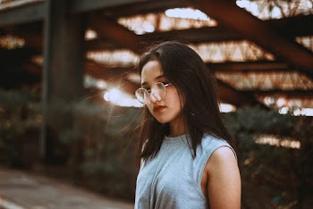 Woman Wearing Eyeglasses and Teal Tank Top