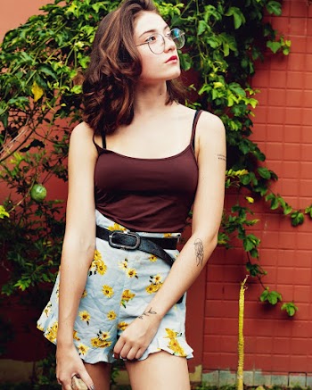 Woman Wearing Eyeglasses Behind Wall