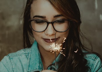 Woman Wearing Eyeglasses Holding Sparkleer