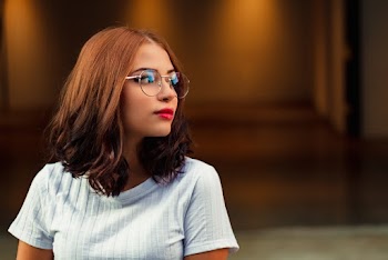 Woman Wearing Eyeglasses Looking At The Side