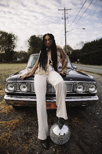 Woman Wearing Eyeglasses Sitting on Car