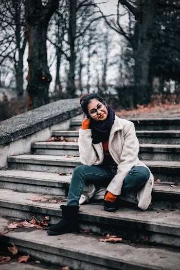 Woman Wearing Eyeglasses Sitting Outdoor