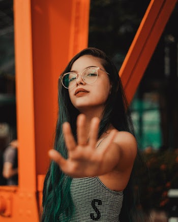 Woman Wearing Eyeglasses Standing Near Post