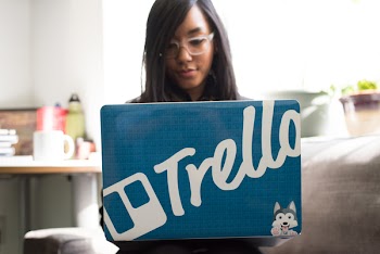 Woman Wearing Eyeglasses Using Blue and and Gray Laptop Inside Room