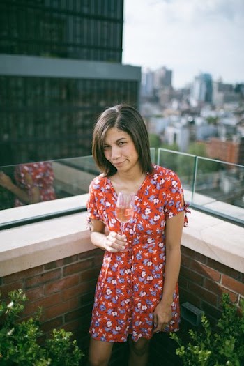 Woman Wearing Floral Dress Holding Wine Glass