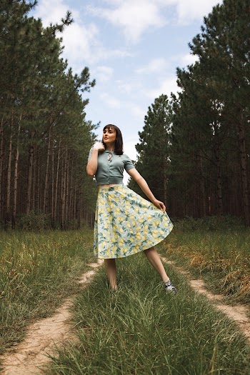 Woman Wearing Floral Skirt Standing On Grass Road