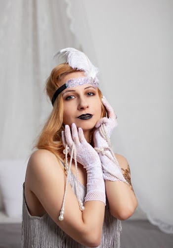 Woman Wearing Gloves And Sleeveless Top Touching Her Face