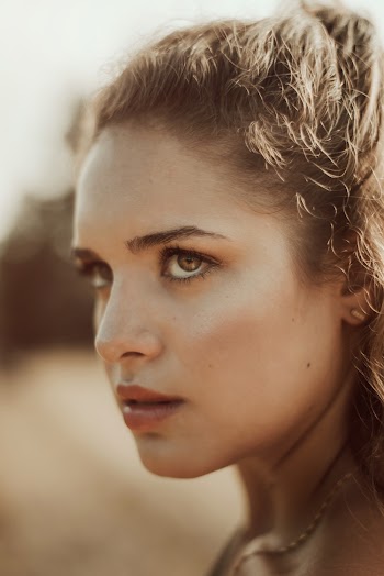 Woman Wearing Gold-colored Necklace