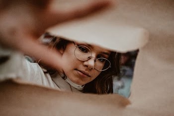 woman wearing gold framed eyeglasses