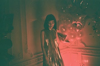 Woman Wearing Gold Sleeveless Dress Standing While Looking Down