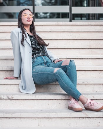 Woman Wearing Gray Blazer Sitting on Brown Stairs