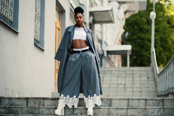 Woman Wearing Gray Coat and White Crop Top on Staircase