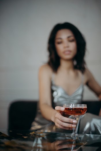 Woman Wearing Gray Dress Holding Wine Glass