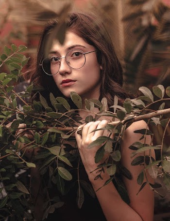Woman Wearing Gray Eyeglasses Holding Tree