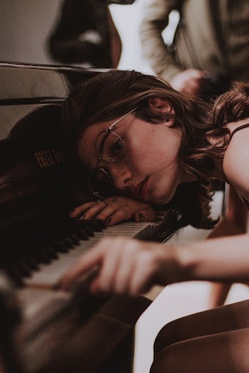 Woman Wearing Gray Framed Eyeglasses Playing Piano