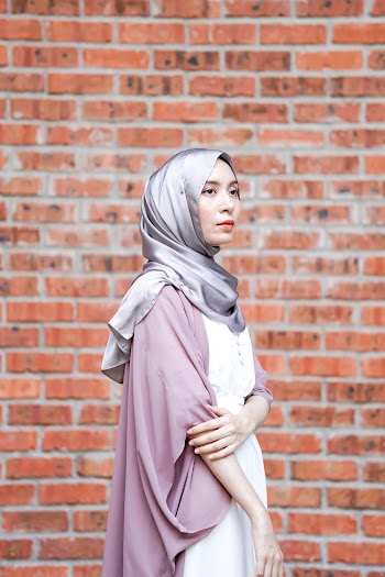Woman Wearing Gray Hijab While Standing Near Brick Wall