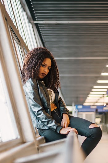 Woman Wearing Gray Jacket And Ripped Jeans