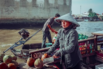 Woman Wearing Gray Jacket Riding on Canoe Boat