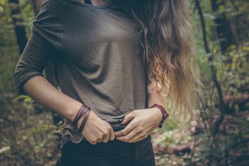 Woman Wearing Gray Long Sleeve Shirt Holding on Her Waist