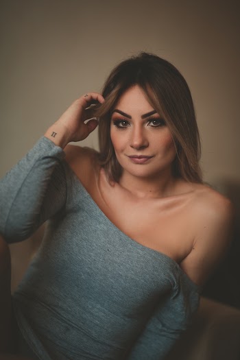 Woman Wearing Gray Long-sleeved Off-shoulder Dress With Hand on Hair