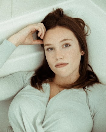 Woman Wearing Gray Long-sleeved Top Lying on Bathtub