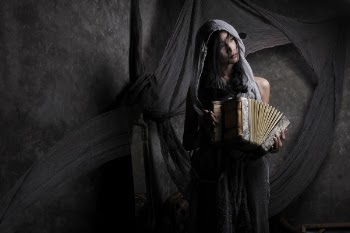 Woman Wearing Gray Scarf Holding Accordion