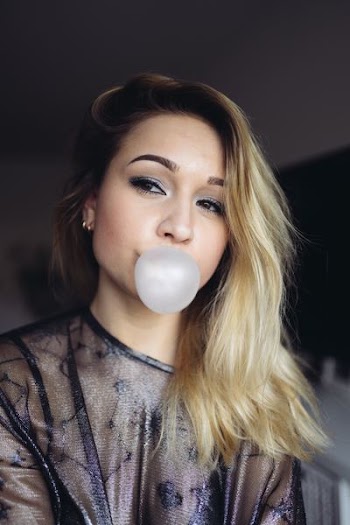woman wearing gray sheer scoop-neck shirt