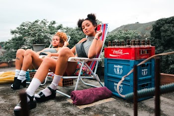Woman Wearing Gray Turtleneck Sleeveless Top Beside Coca-cola Crate